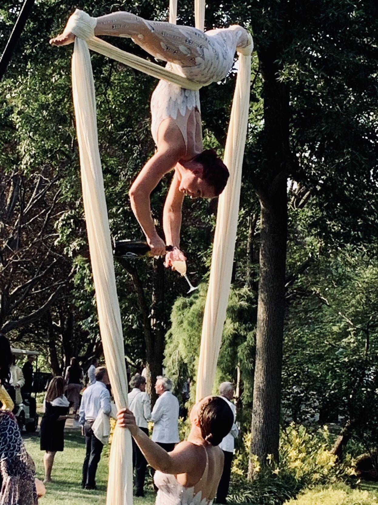 Acrobats serving champagne